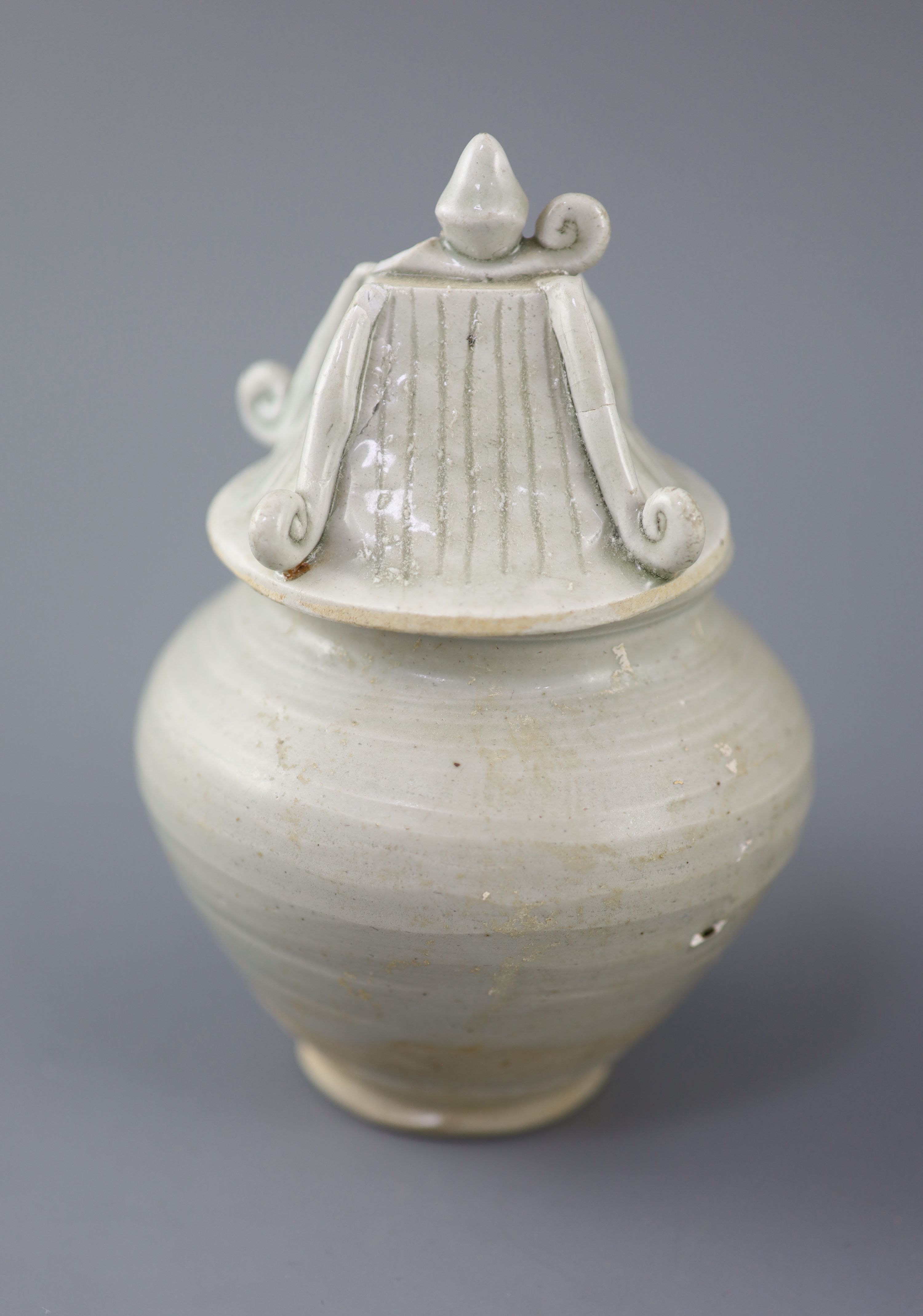 A Chinese cream glazed ovoid jar, Tang dynasty and a Ding type jar and cover, Yuan dynasty,
